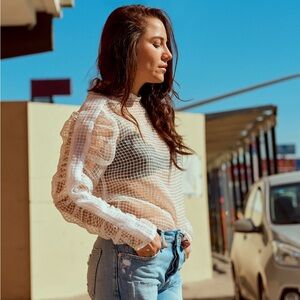 White sheet top with ruched sleeve details.